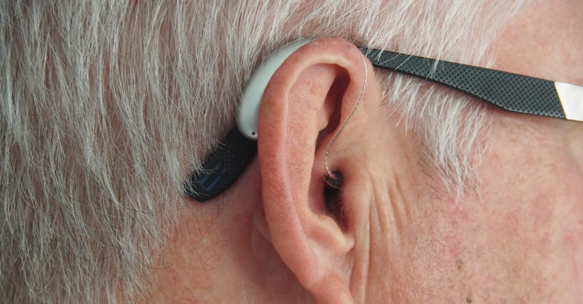 A closeup of a man with a hearing aid